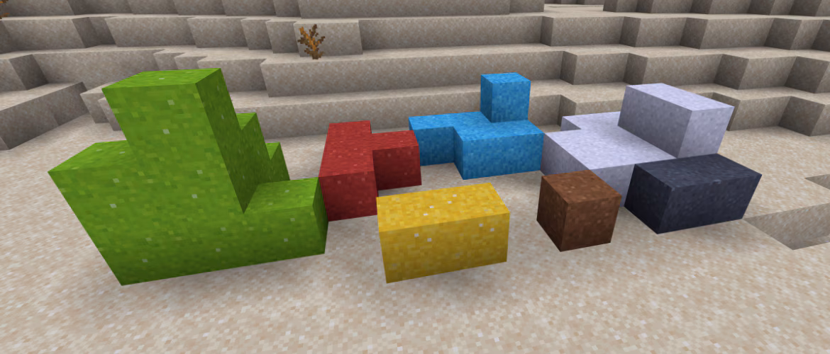 Minecraft concrete powder blocks in several colors arranged in a desert